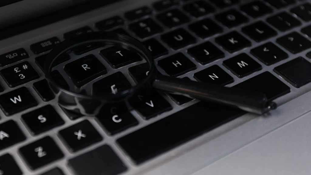 a magnifying glass on a keyboard