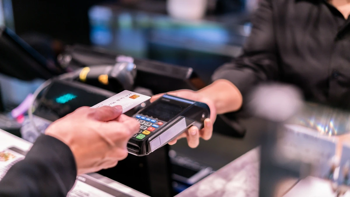 a man paying for a transaction with his credit card