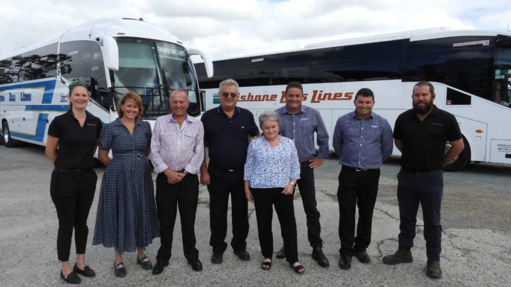 The Kangaroo Bus Lines team posing with both buses