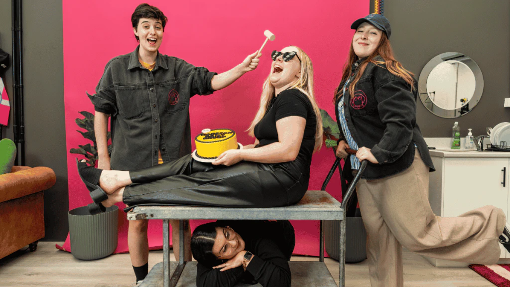 The Lange Creative Lab team posing with a smash cake