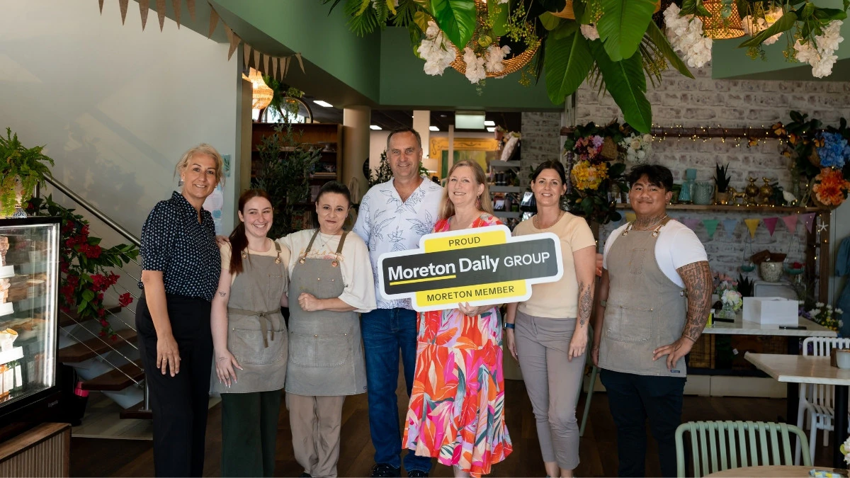 Employees at the Redcliffe Treehouse with Moreton Daily's Lyndsay Lawler, celebrating the strategic partnership